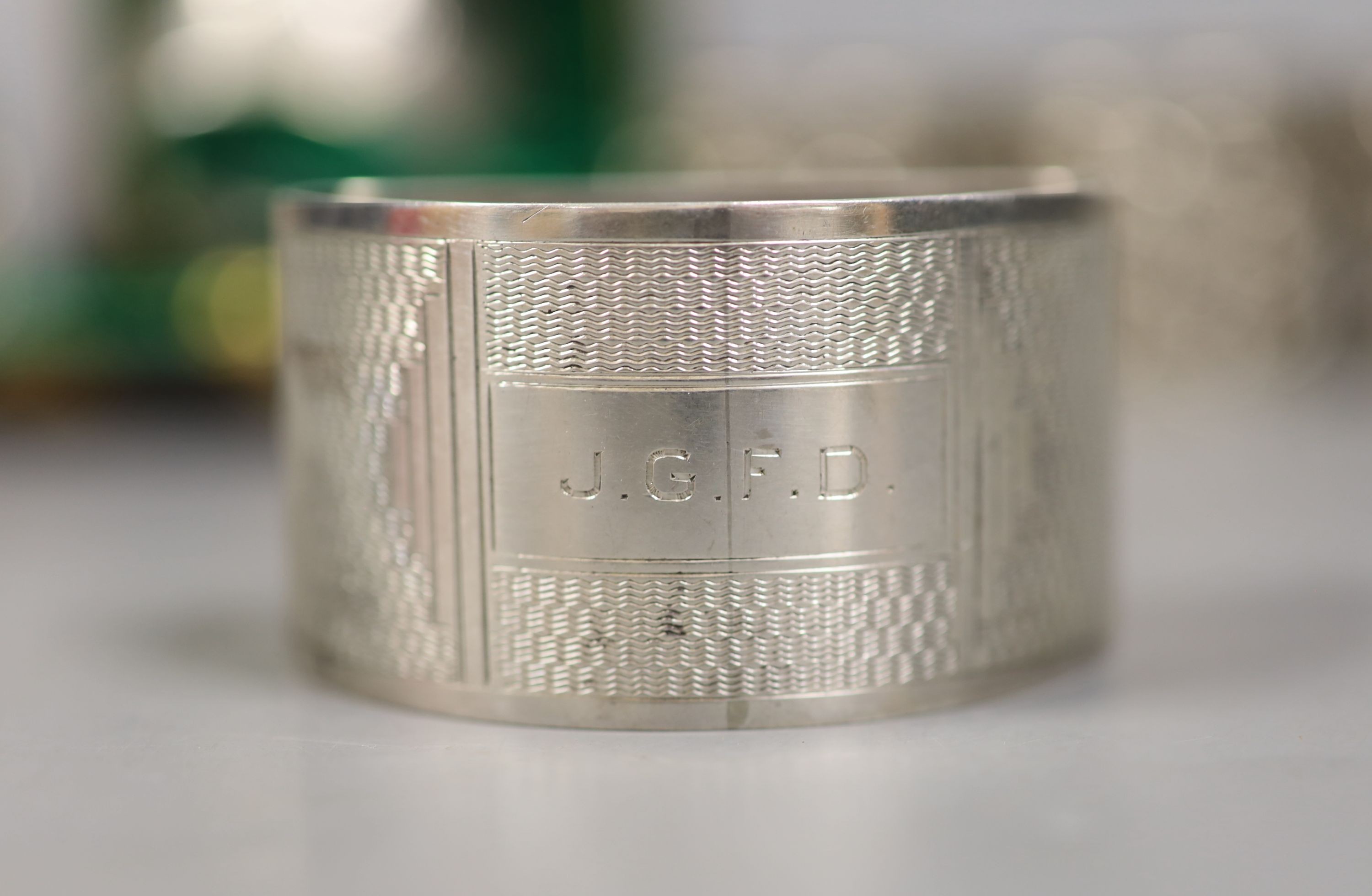 A set of four Victorian embossed silver napkin rings, A & J. Zimmerman, Birmingham, 1889 and four other silver napkin rings including one cased, 7.5oz.